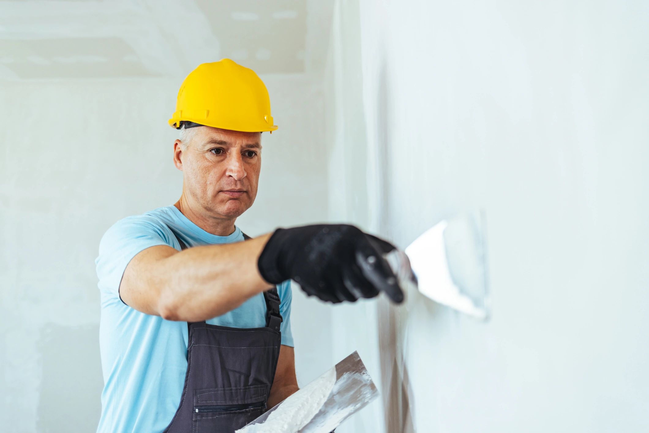 Contractor repairing an interior wall