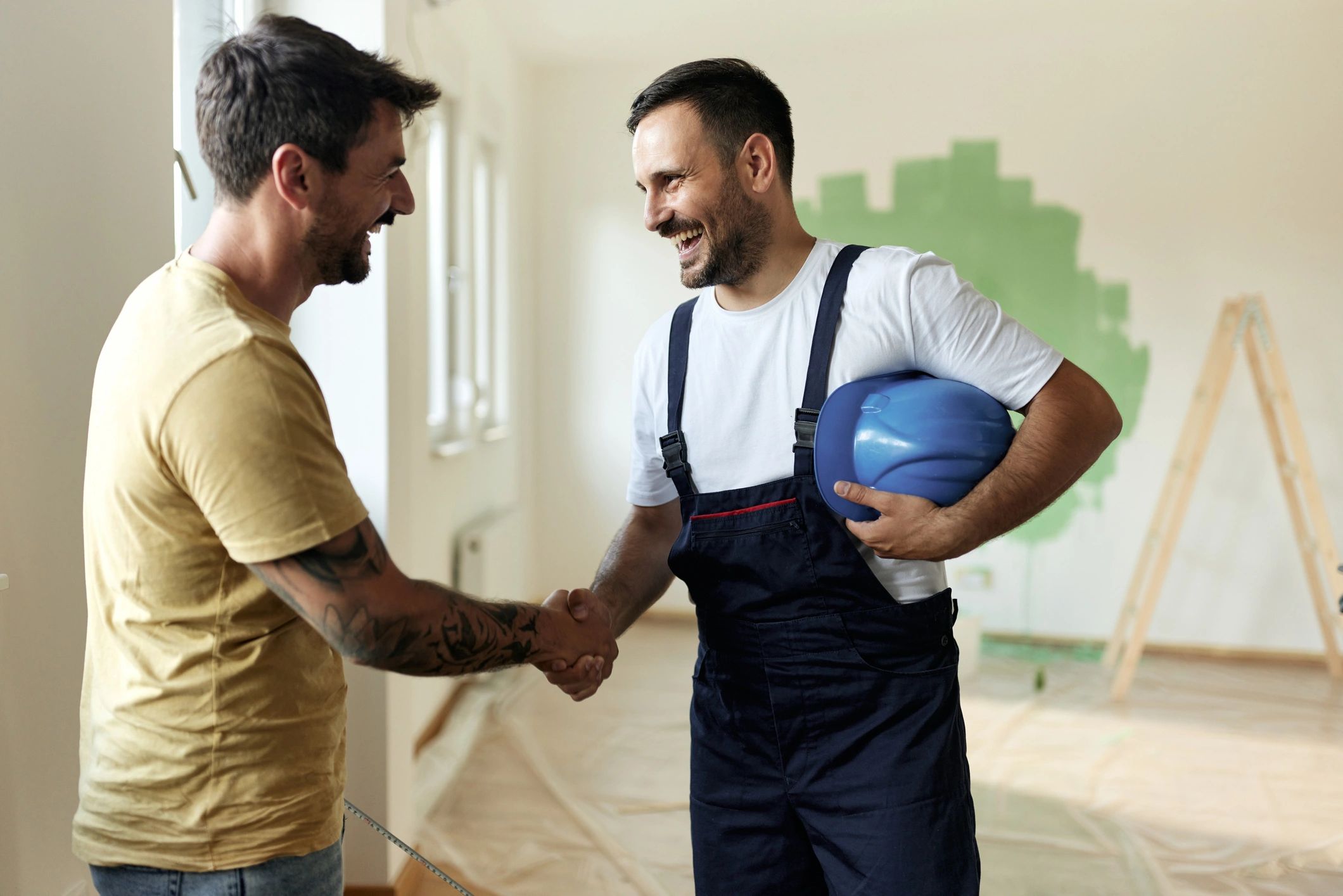 Customer and contractor handshake after a home improvement agreement